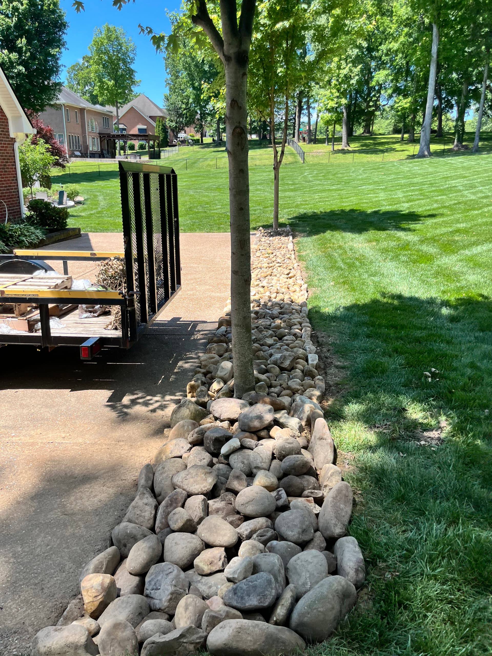 River Rock Bed Install That Cuts Yard Work Down for Good image